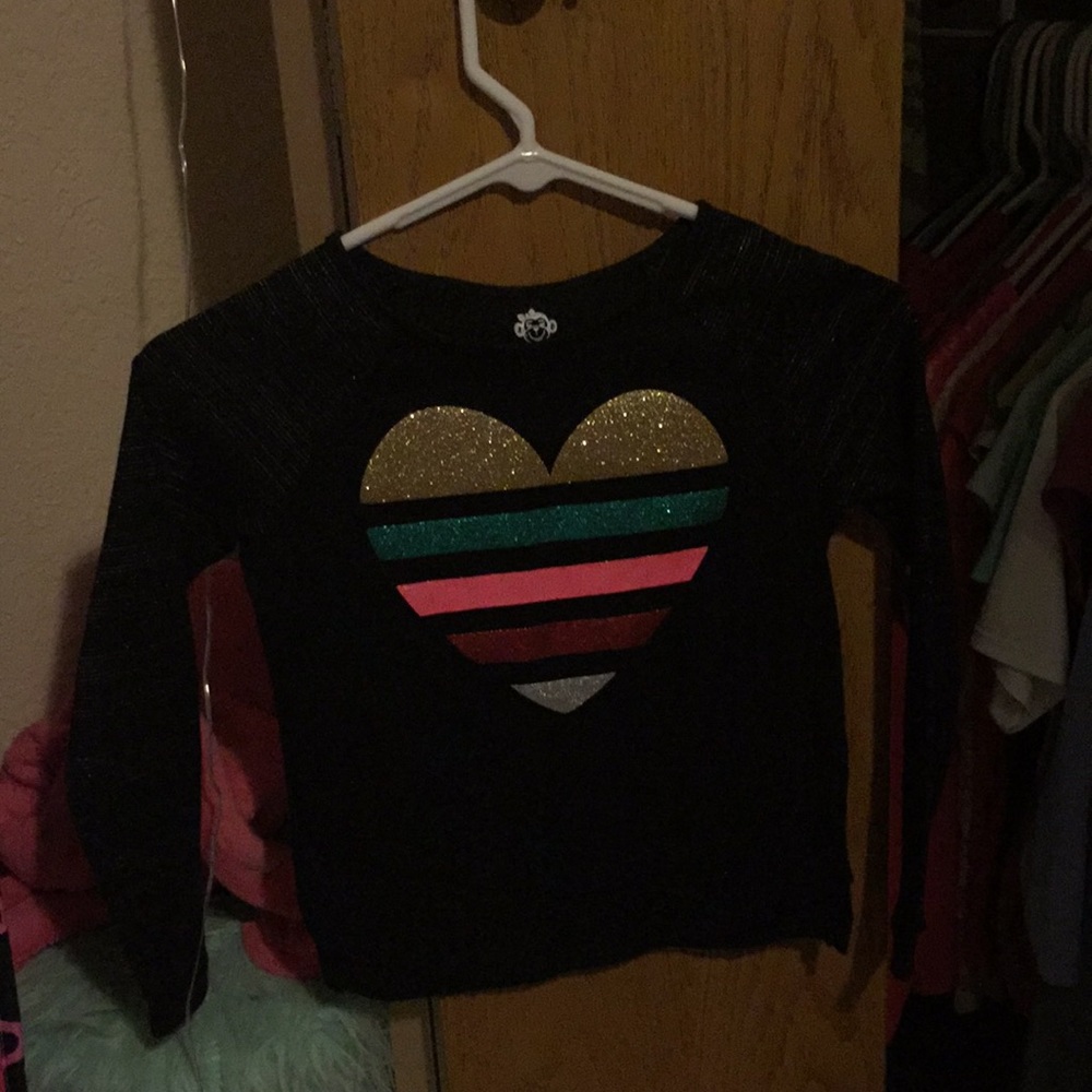 A black T-shirt with a heart on top.